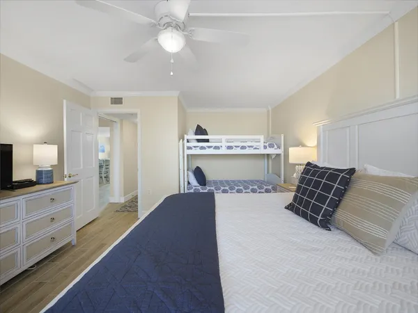 a bedroom with a large bed and chandelier