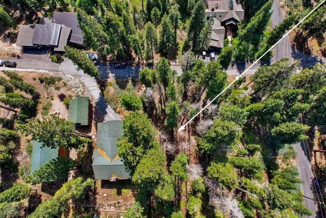 an aerial view of multiple houses with yard