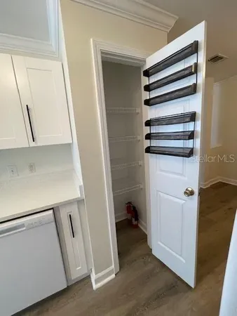 a kitchen with a sink and wooden floor