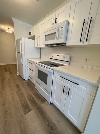 a view of a kitchen with a sink and cabinets