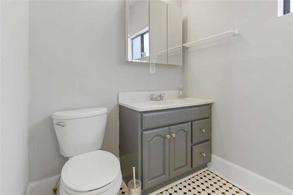 693 Myrtle Street Northeast, Unit 2 Atlanta, GA 30308 - Photo 12 of 17 a bathroom with a sink toilet and mirror