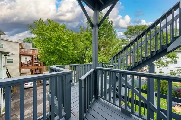 a view of roof deck with wooden fence and floor