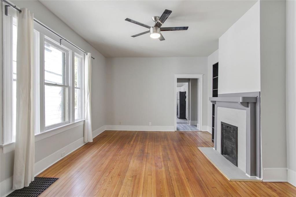 693 Myrtle Street Northeast, Unit 2 Atlanta, GA 30308 - Photo 6 of 17 a view of empty room with wooden floor and fireplace
