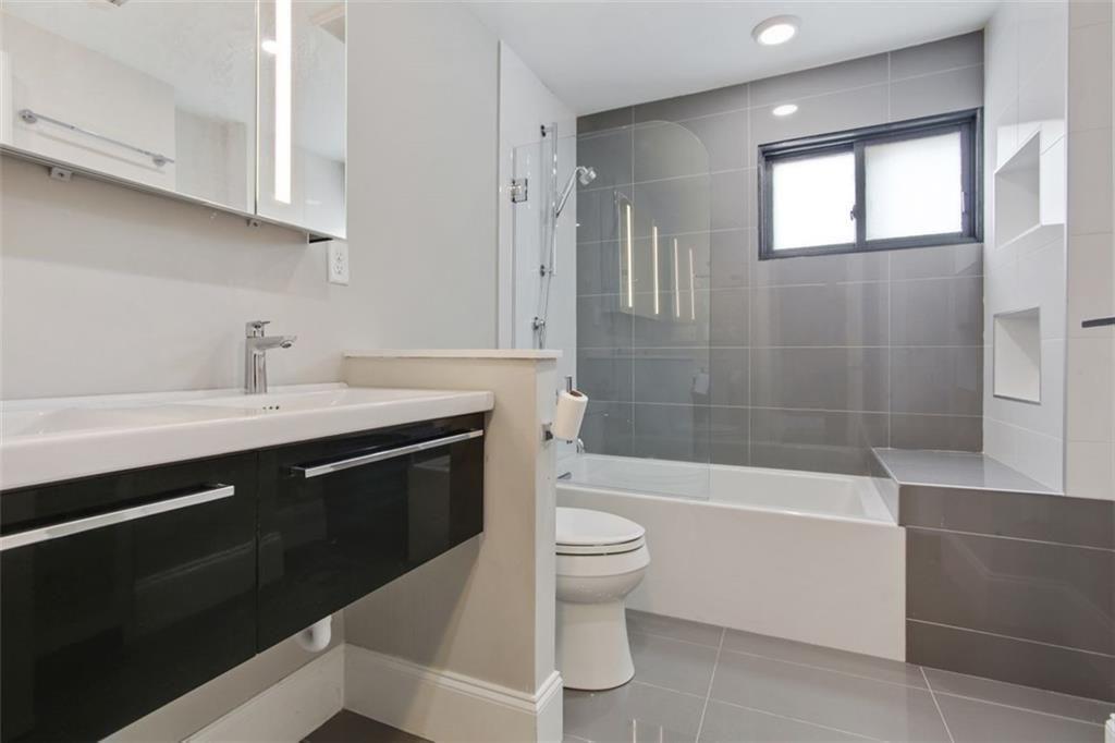 693 Myrtle Street Northeast, Unit 2 Atlanta, GA 30308 - Photo 10 of 17 a bathroom with a sink a toilet and bathtub