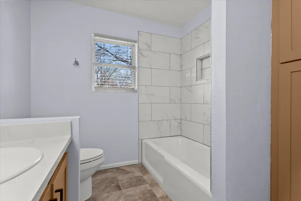a bathroom with a sink a toilet and bathtub