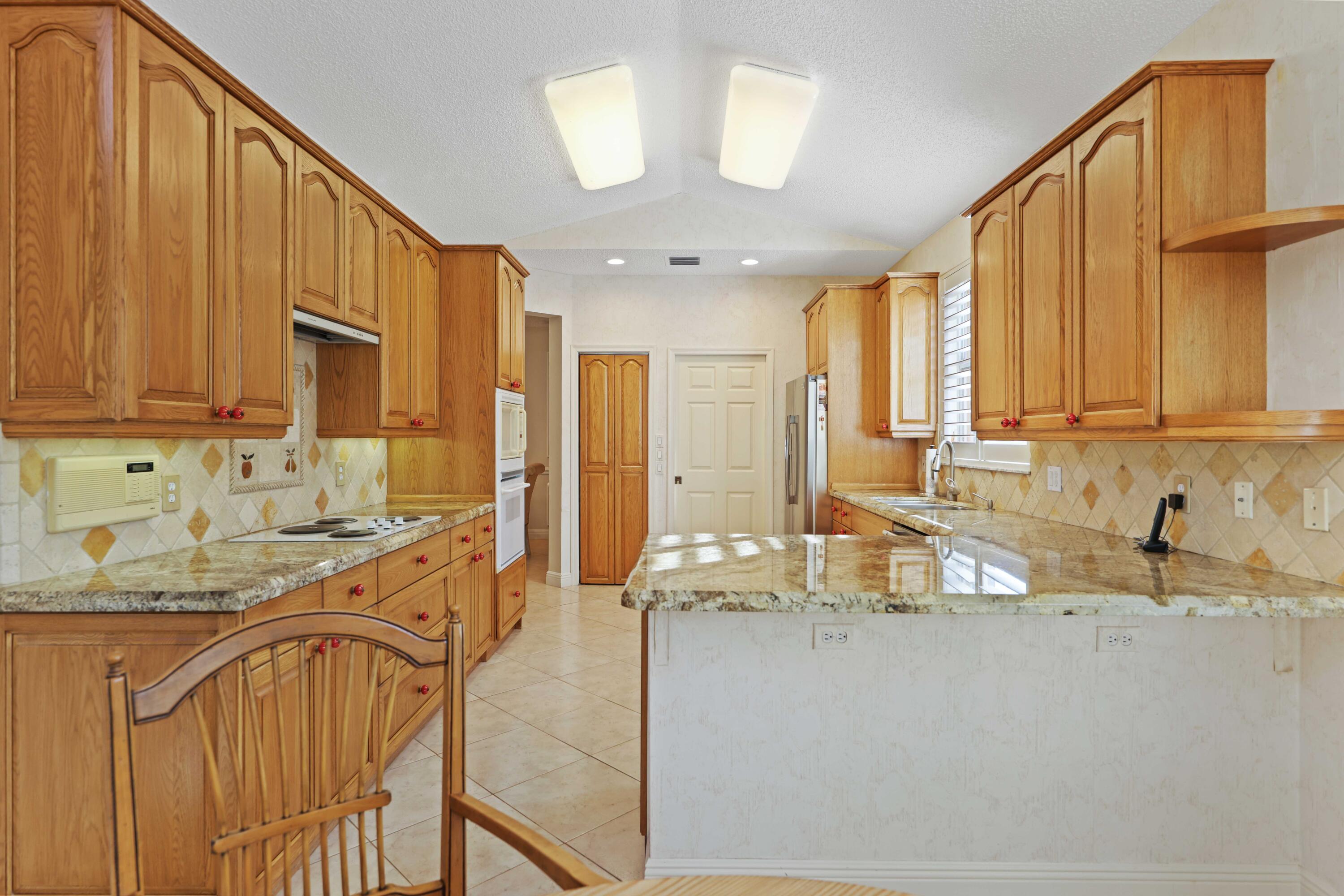 7633 La Corniche Circle Boca Raton, FL 33433 - Photo 17 of 49 a view of a kitchen with a window