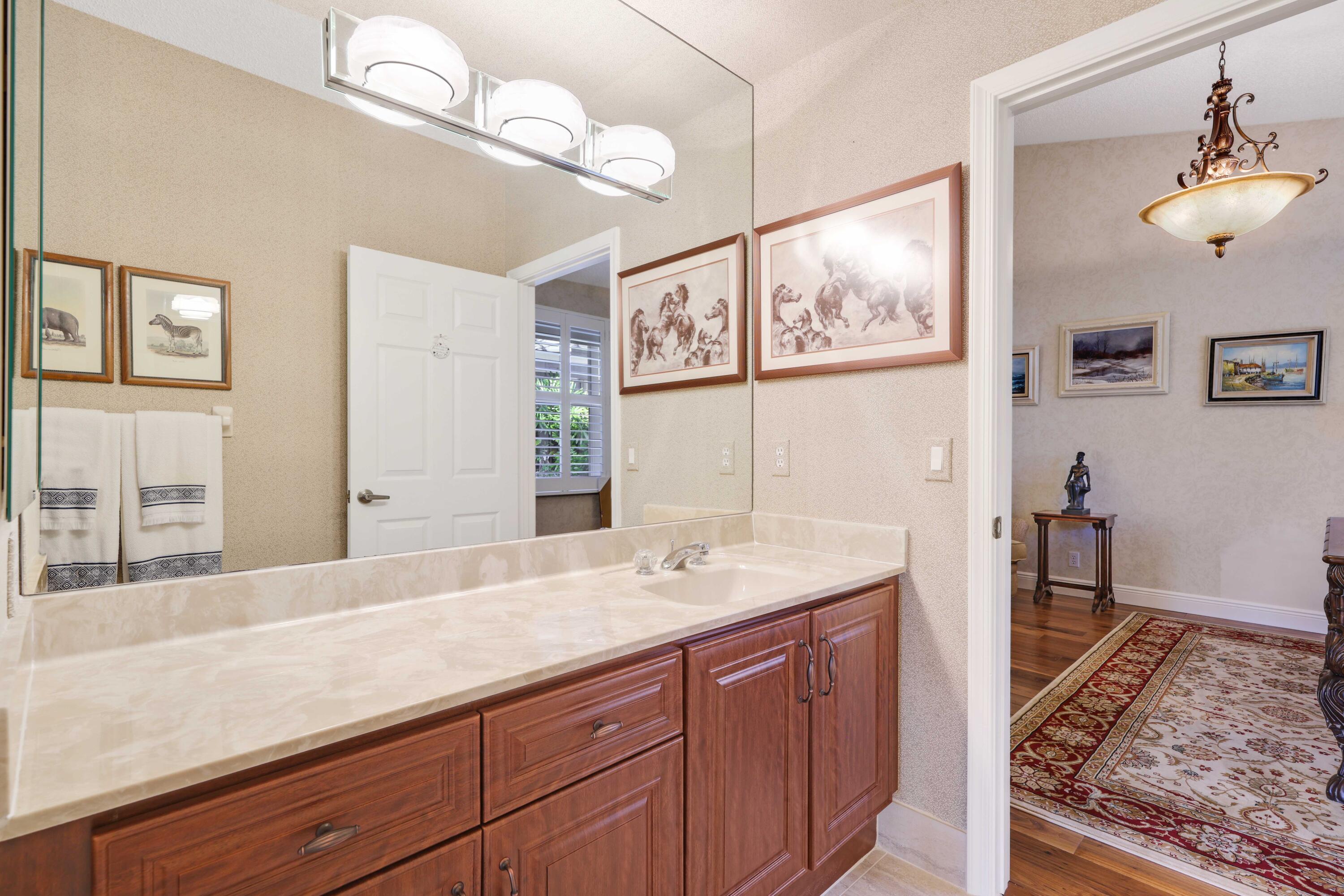 7633 La Corniche Circle Boca Raton, FL 33433 - Photo 22 of 49 a bathroom with a sink a vanity and a large mirror