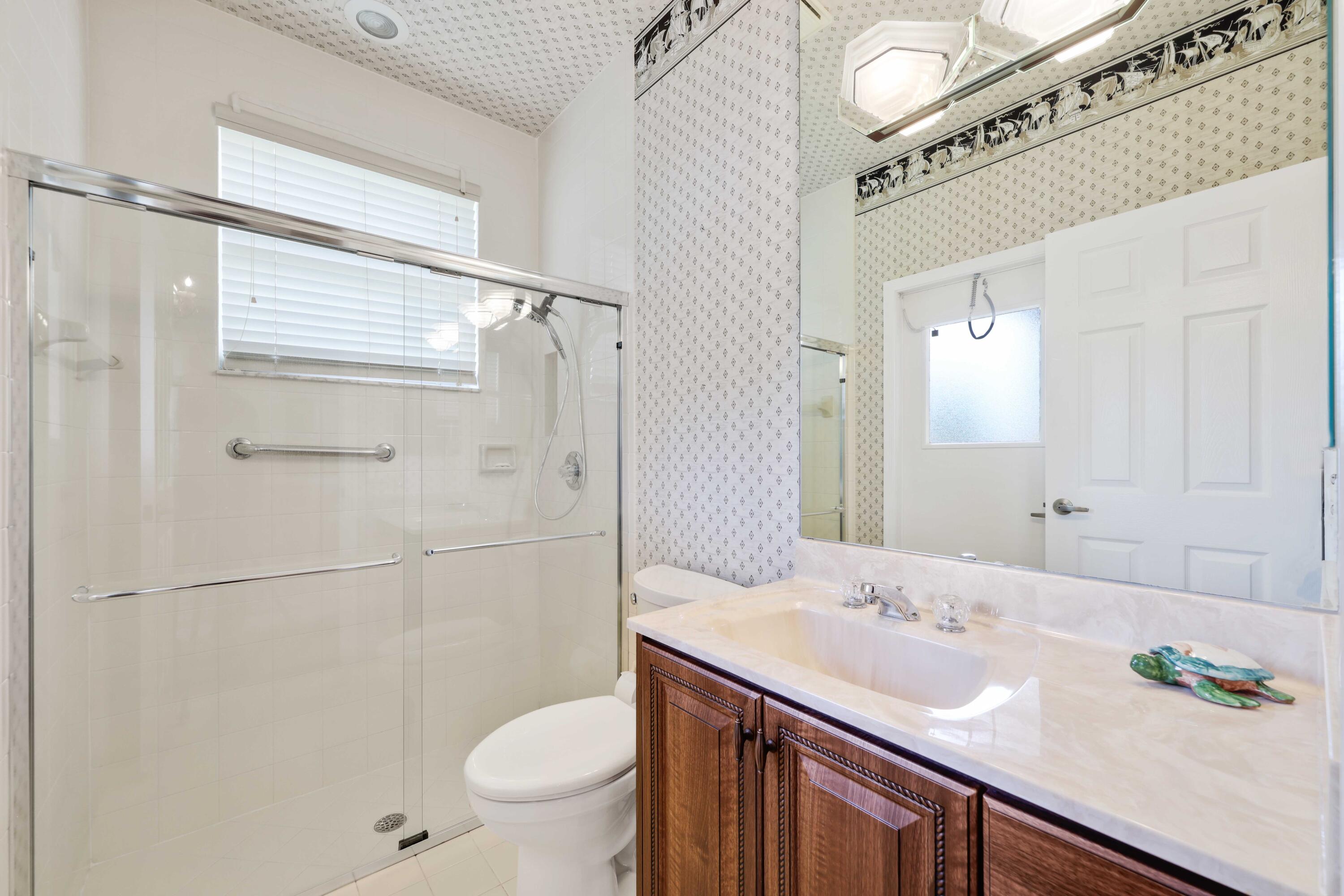 7633 La Corniche Circle Boca Raton, FL 33433 - Photo 36 of 49 a bathroom with a sink a toilet and shower