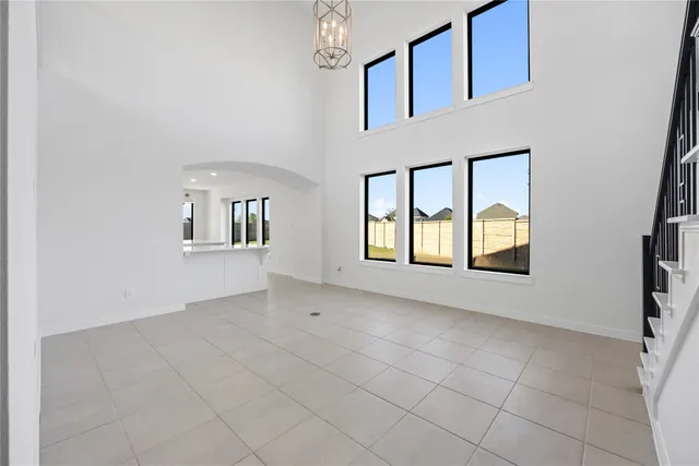 an empty room with windows and entrance