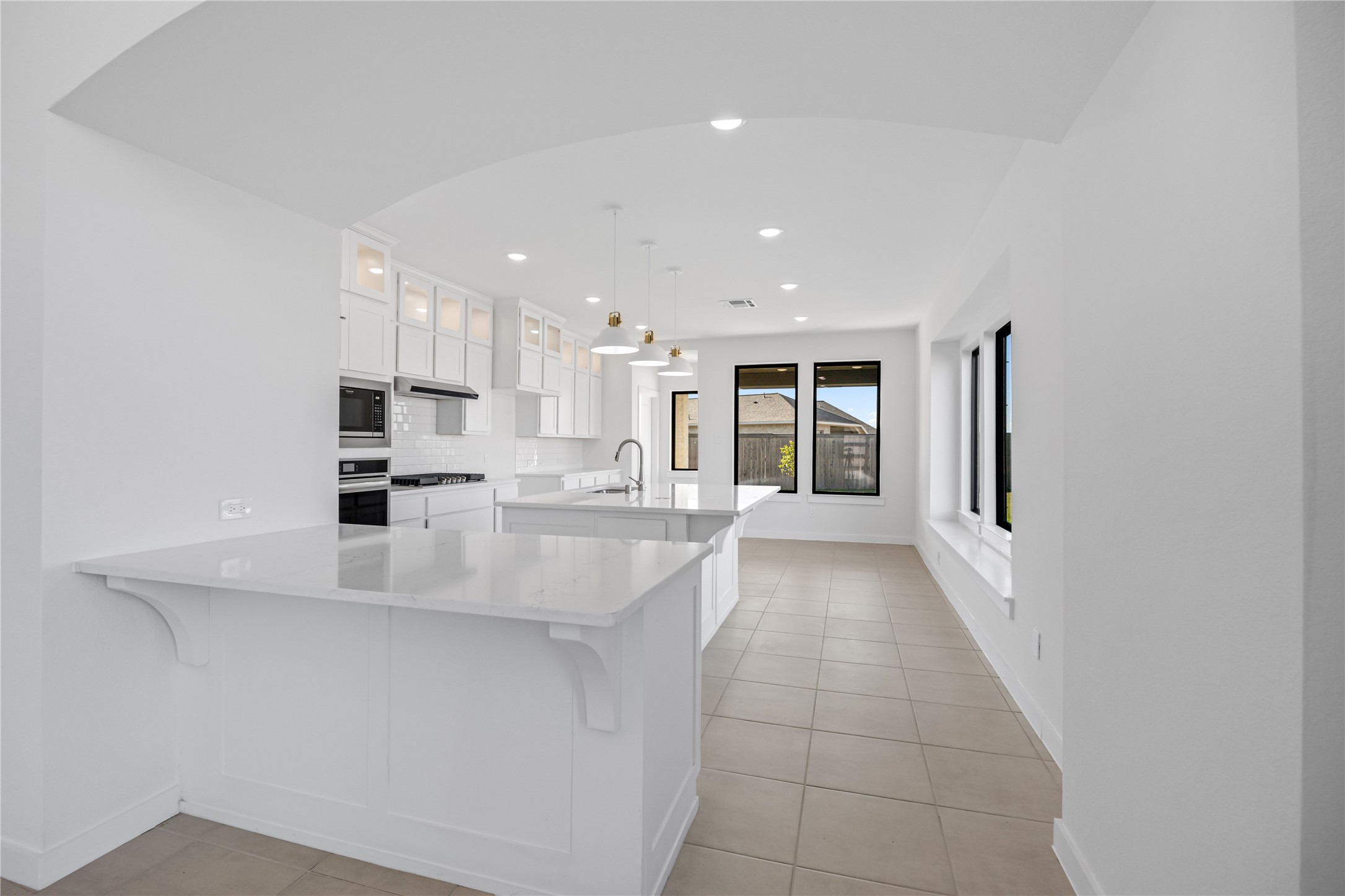 5106 Sistine Drive Manvel, TX 77578 - Photo 7 of 42 a large kitchen with kitchen island a sink stainless steel appliances and cabinets