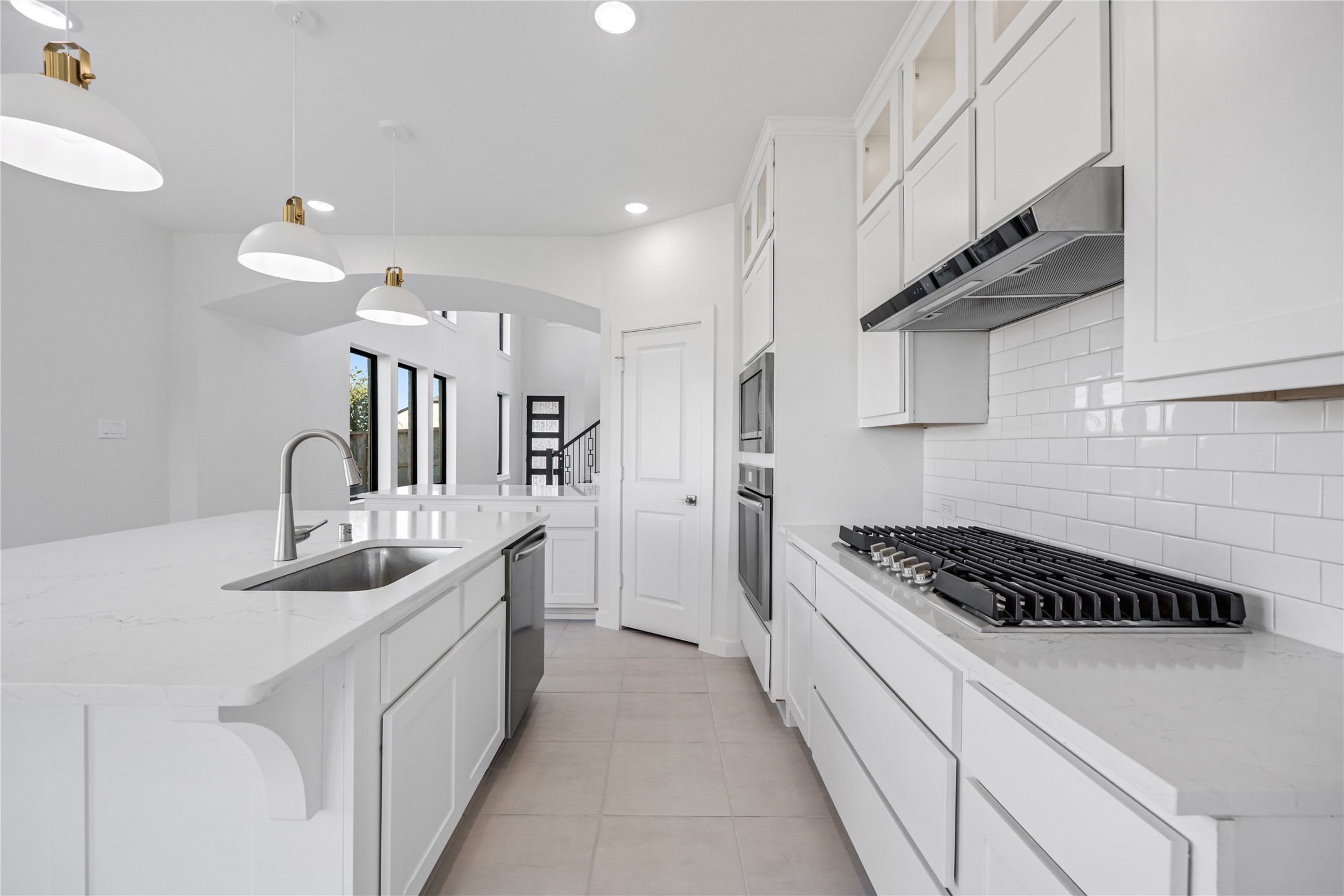 5106 Sistine Drive Manvel, TX 77578 - Photo 9 of 42 a kitchen with granite countertop a sink stove and cabinets