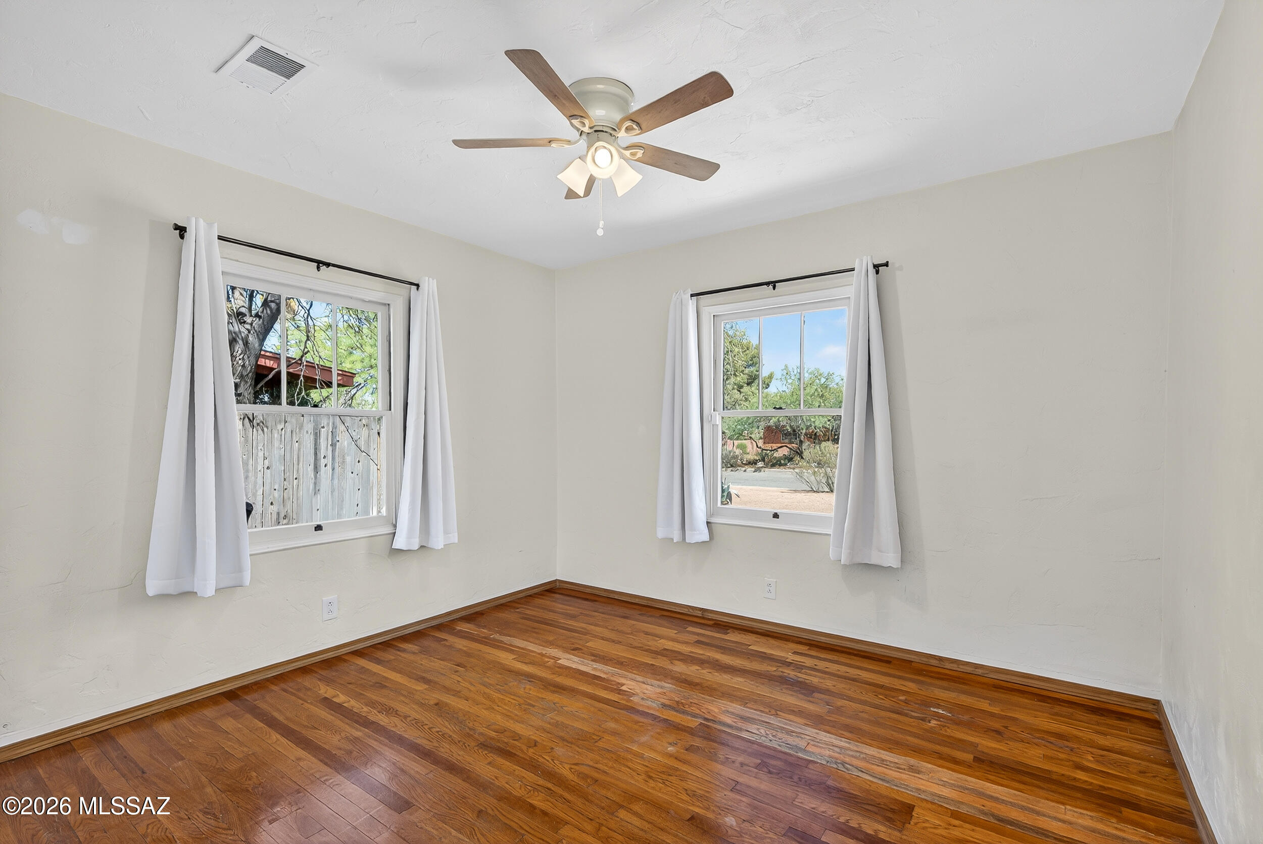 1412 East Spring Street Tucson, AZ 85719 - Photo 30 of 43 an empty room with wooden floor and windows