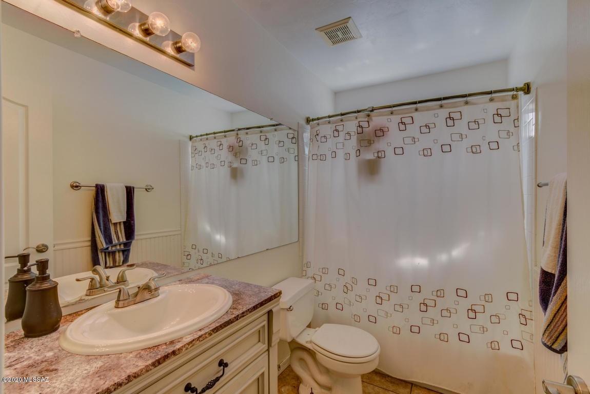 5311 West Fireopal Way Tucson, AZ 85742 - Photo 12 of 14 a bathroom with a granite countertop sink toilet and shower