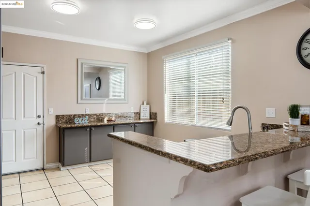 a kitchen with granite countertop a stove a sink and a granite counter tops