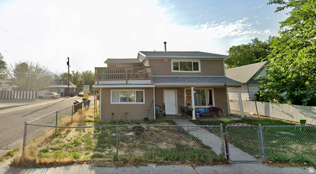 7805 South Main Street Midvale, UT 84047 - Photo 2 of 5 Traditional-style home with a gate and a fenced front yard