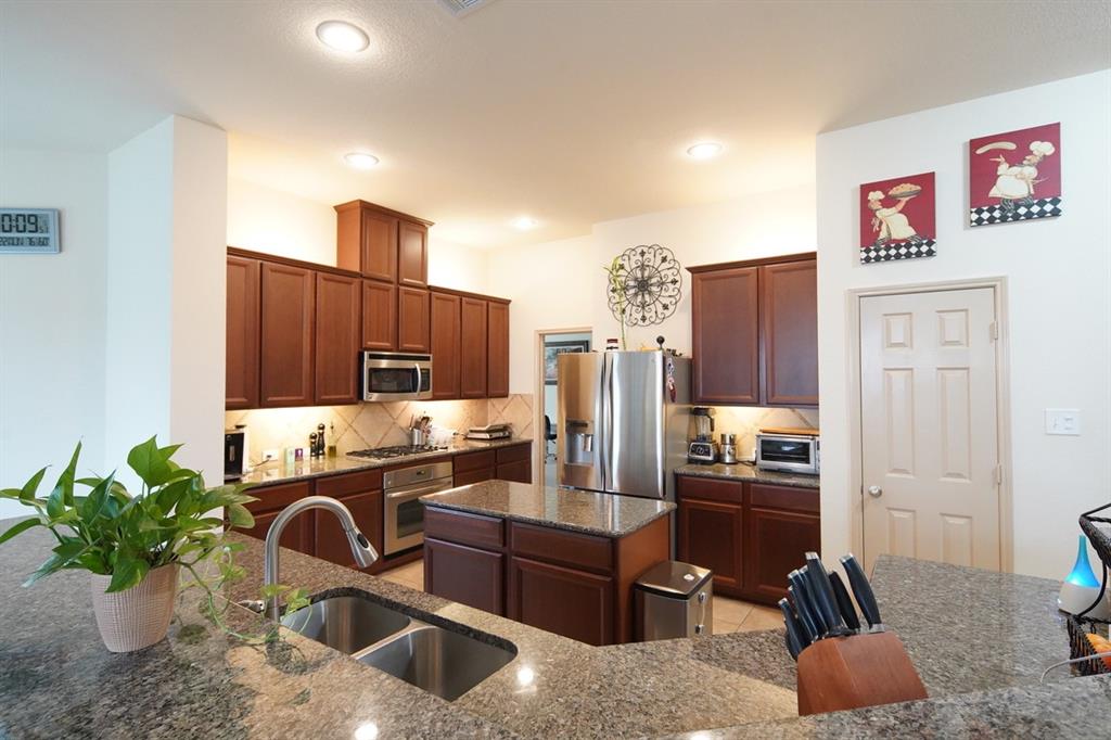 4508 Fox Rio Trail Arlington, TX 76017 - Photo 8 of 28 a kitchen with a refrigerator and a stove