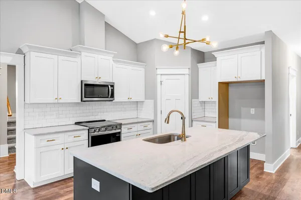 a kitchen with a stove a sink and a refrigerator