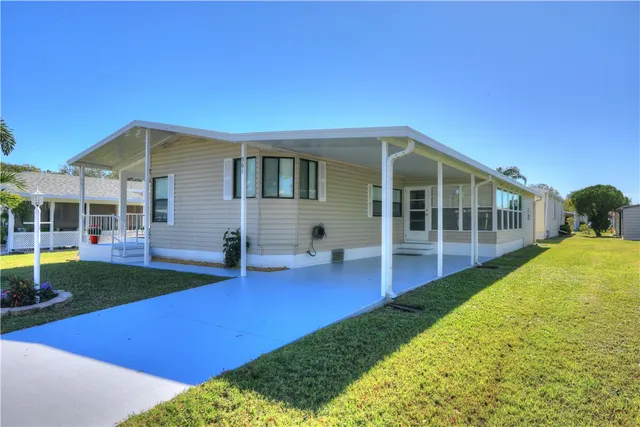 a view of an house with backyard space and balcony