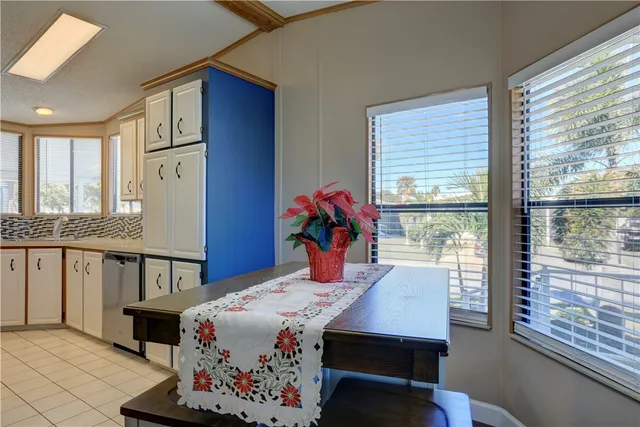 a bedroom with a bed a dresser and windows