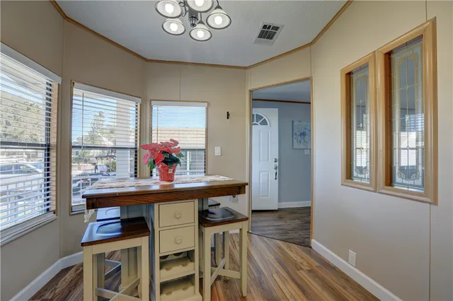a view of a dining room with furniture wooden floor and chandelier
