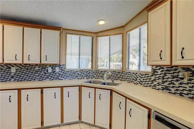 a bathroom with a granite countertop sink and a large mirror