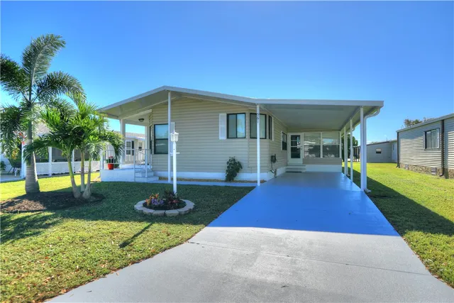 a view of a backyard with table and chairs under an umbrella