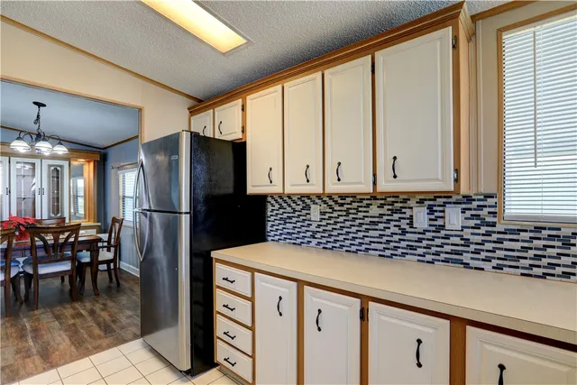 a kitchen with stainless steel appliances a refrigerator and a stove