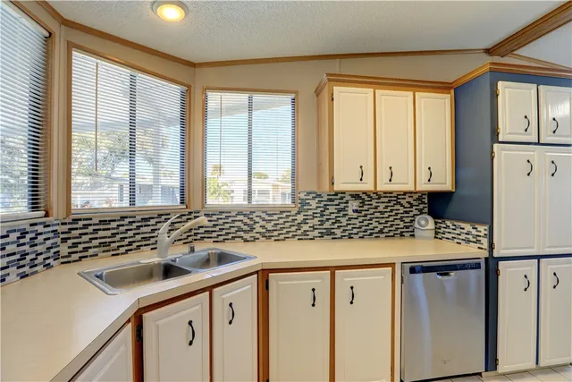 a kitchen with a sink a stove and a refrigerator