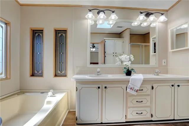 a bathroom with a sink tub and a mirror