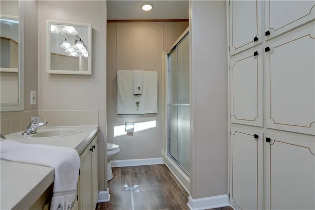 a bathroom with a sink mirror and toilet
