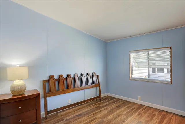 a view of bedroom with furniture and wooden floor