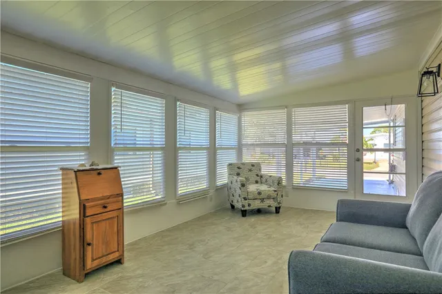 a bedroom with furniture and a large window
