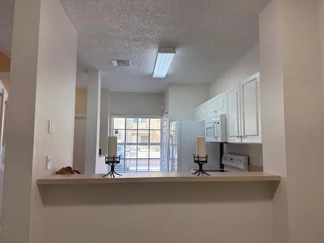 a view of kitchen with wooden floor and window