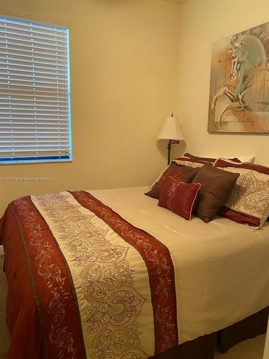 Oasis Homestead, FL 33033 - Photo 11 of 12 a bedroom with a bed and a window