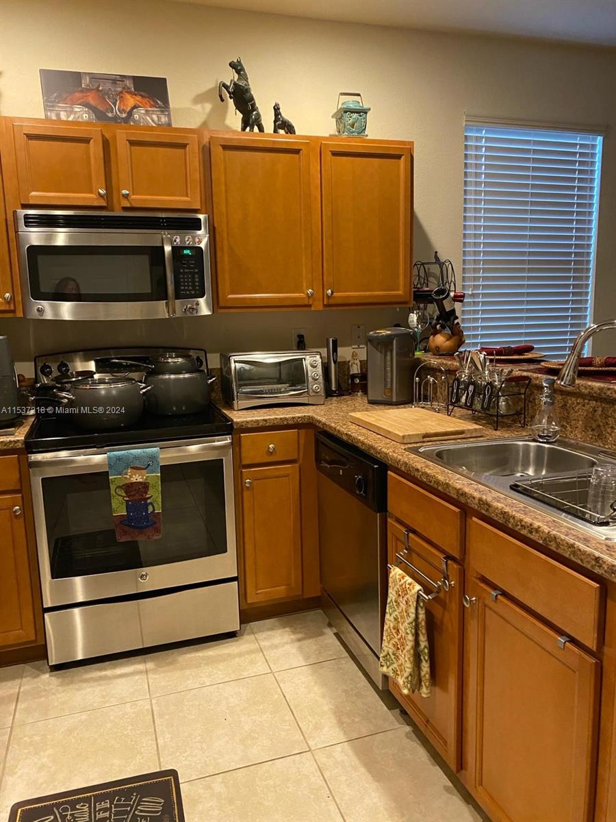 Oasis Homestead, FL 33033 - Photo 3 of 12 a kitchen with a stove and a sink