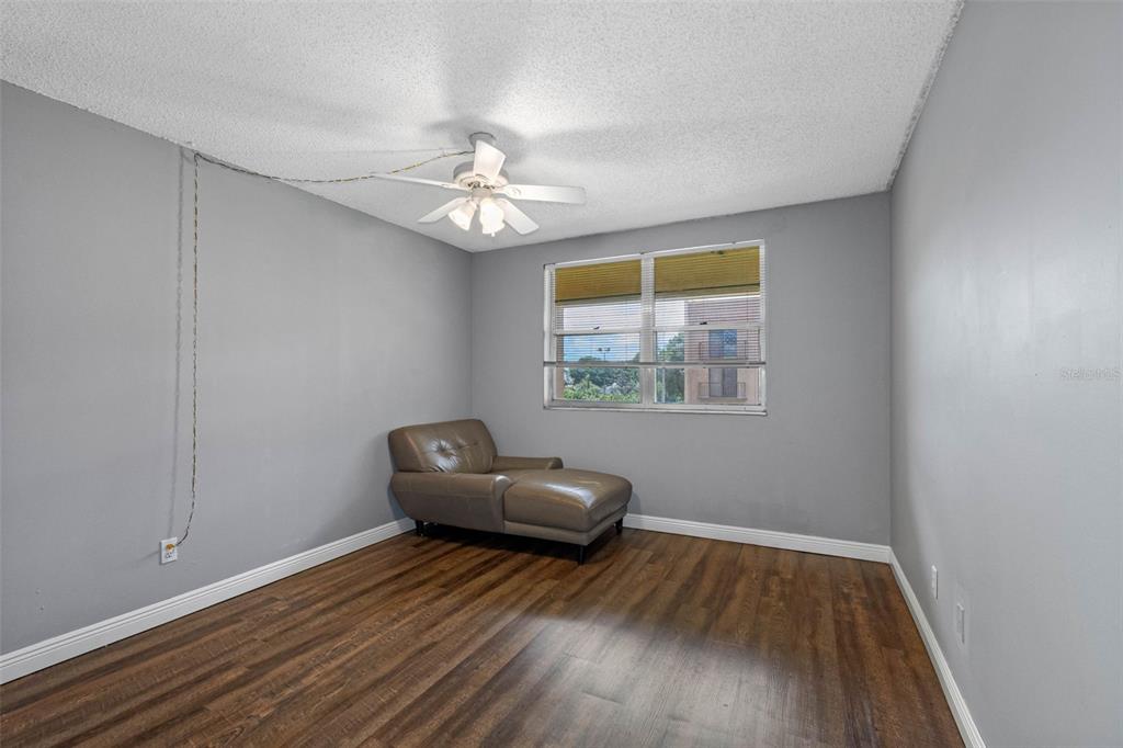 5820 North Church Avenue, Unit 346 Tampa, FL 33614 - Photo 11 of 30 a view of room with wooden floor and ceiling fan