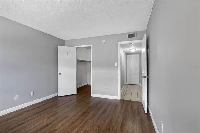 a view of wooden floor and windows in a room