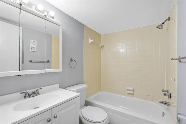 a bathroom with a sink mirror toilet and bathtub