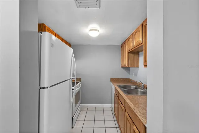 a kitchen with a refrigerator and a stove