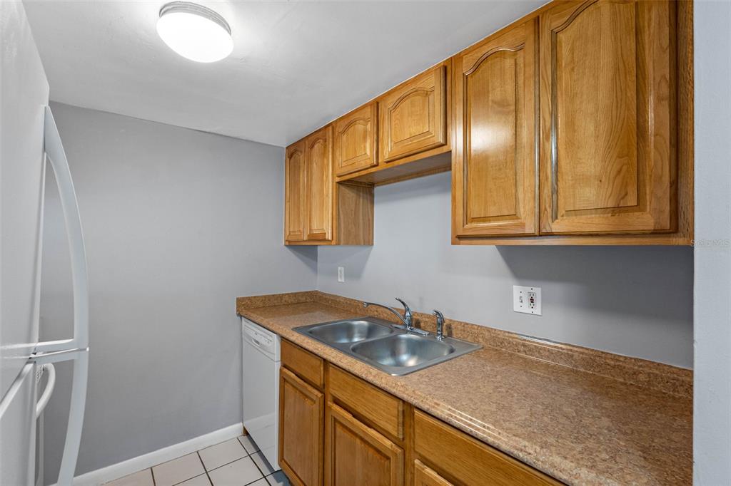 5820 North Church Avenue, Unit 346 Tampa, FL 33614 - Photo 6 of 30 a kitchen with stainless steel appliances granite countertop a sink and cabinets