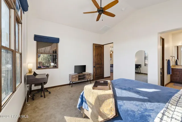 a bed room with a bed window and a desk