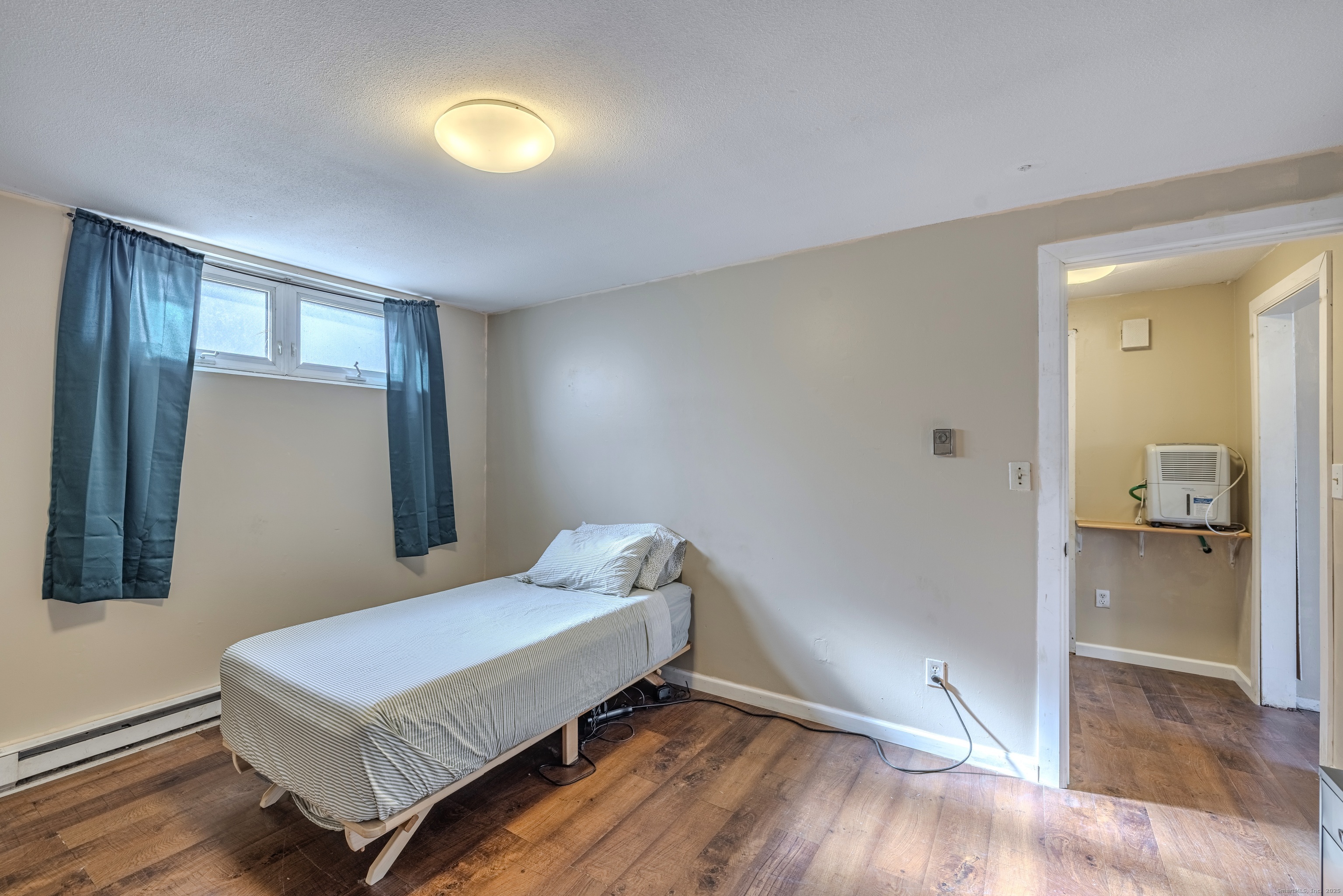 12 A White Oak Road, Unit 12A Mansfield, CT 06268 - Photo 13 of 24 a bedroom with a bed and a mirror