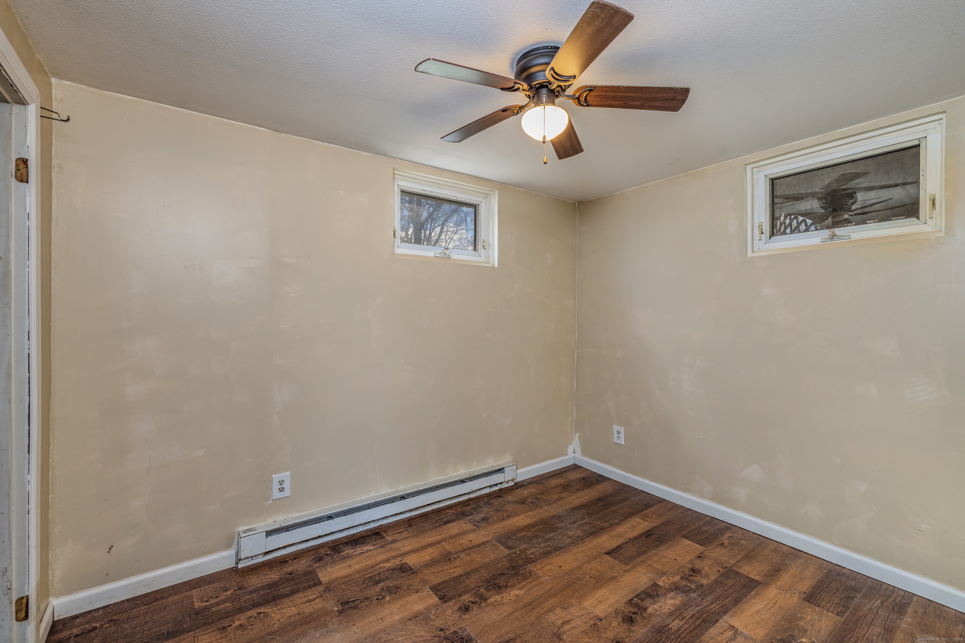 12 A White Oak Road, Unit 12A Mansfield, CT 06268 - Photo 15 of 24 an empty room with a window and a ceiling fan