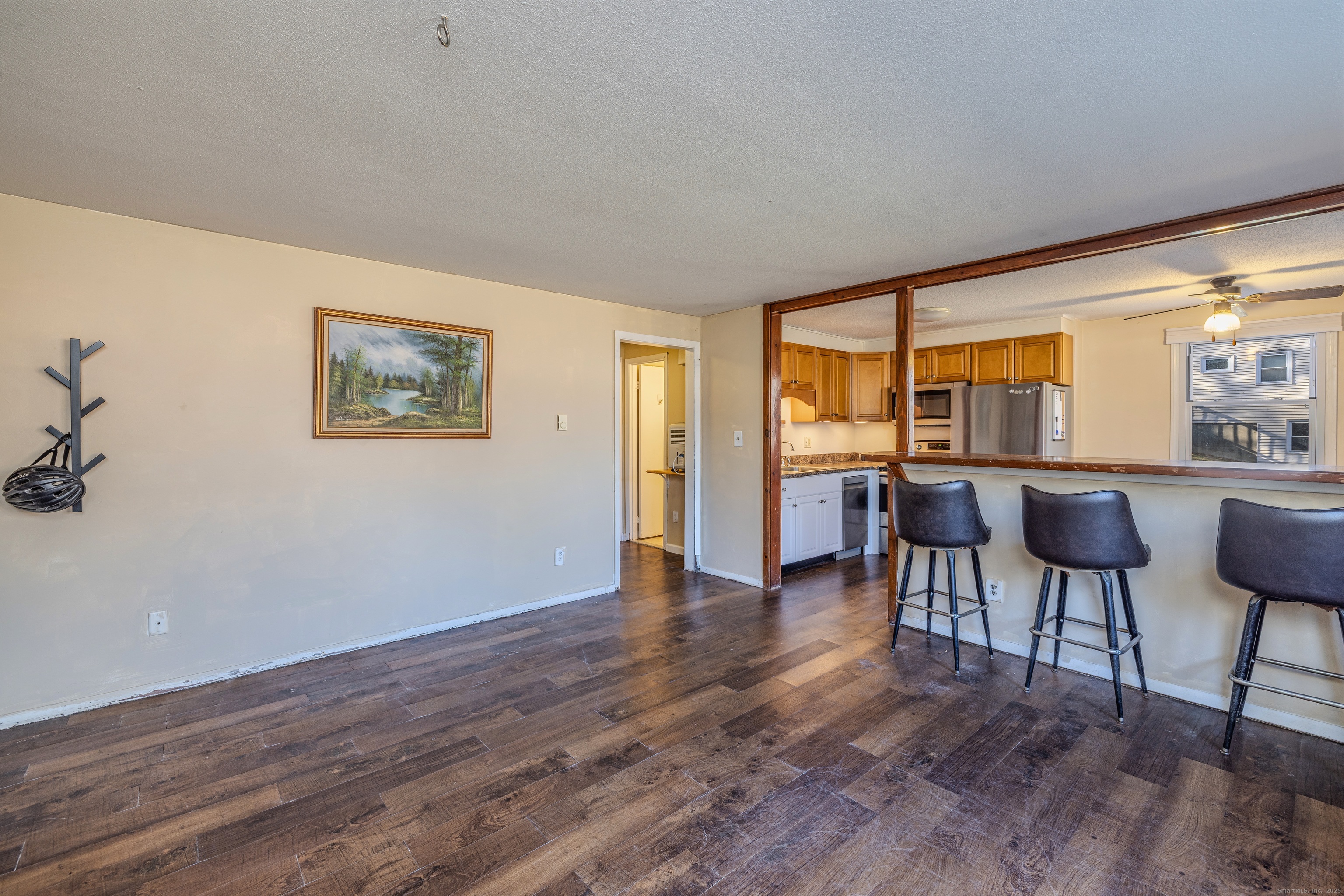 12 A White Oak Road, Unit 12A Mansfield, CT 06268 - Photo 6 of 24 a view of a livingroom with furniture a ceiling fan and wooden floor
