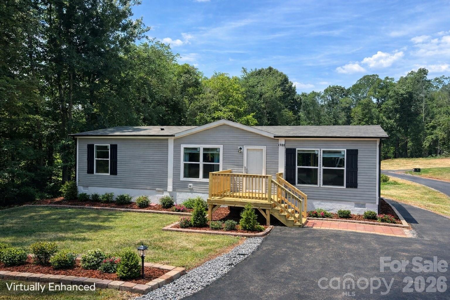 a view of a house with backyard and trees