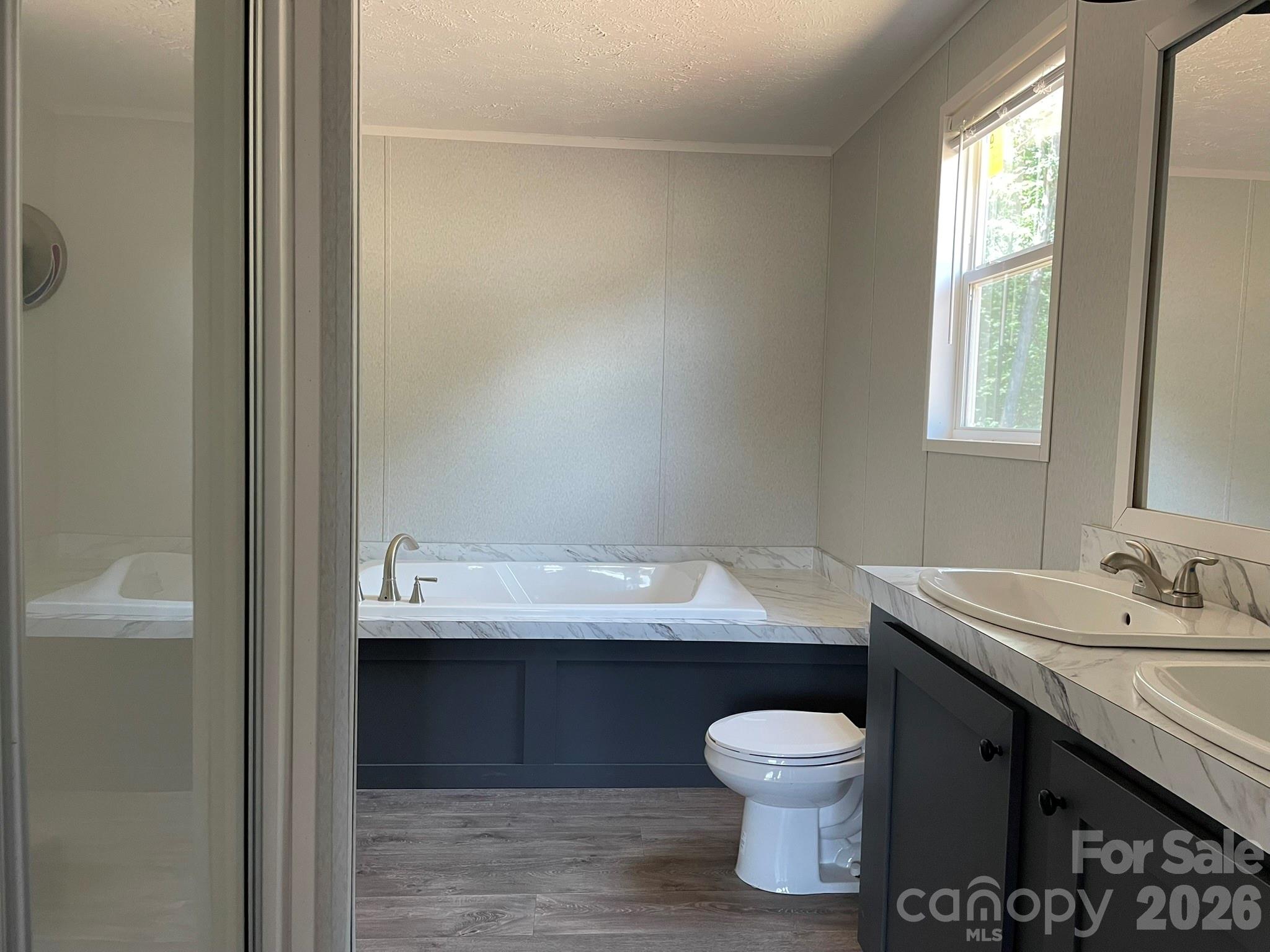 4188 Tallent Road Morganton, NC 28655 - Photo 17 of 21 a bathroom with a granite countertop sink toilet a large mirror and shower