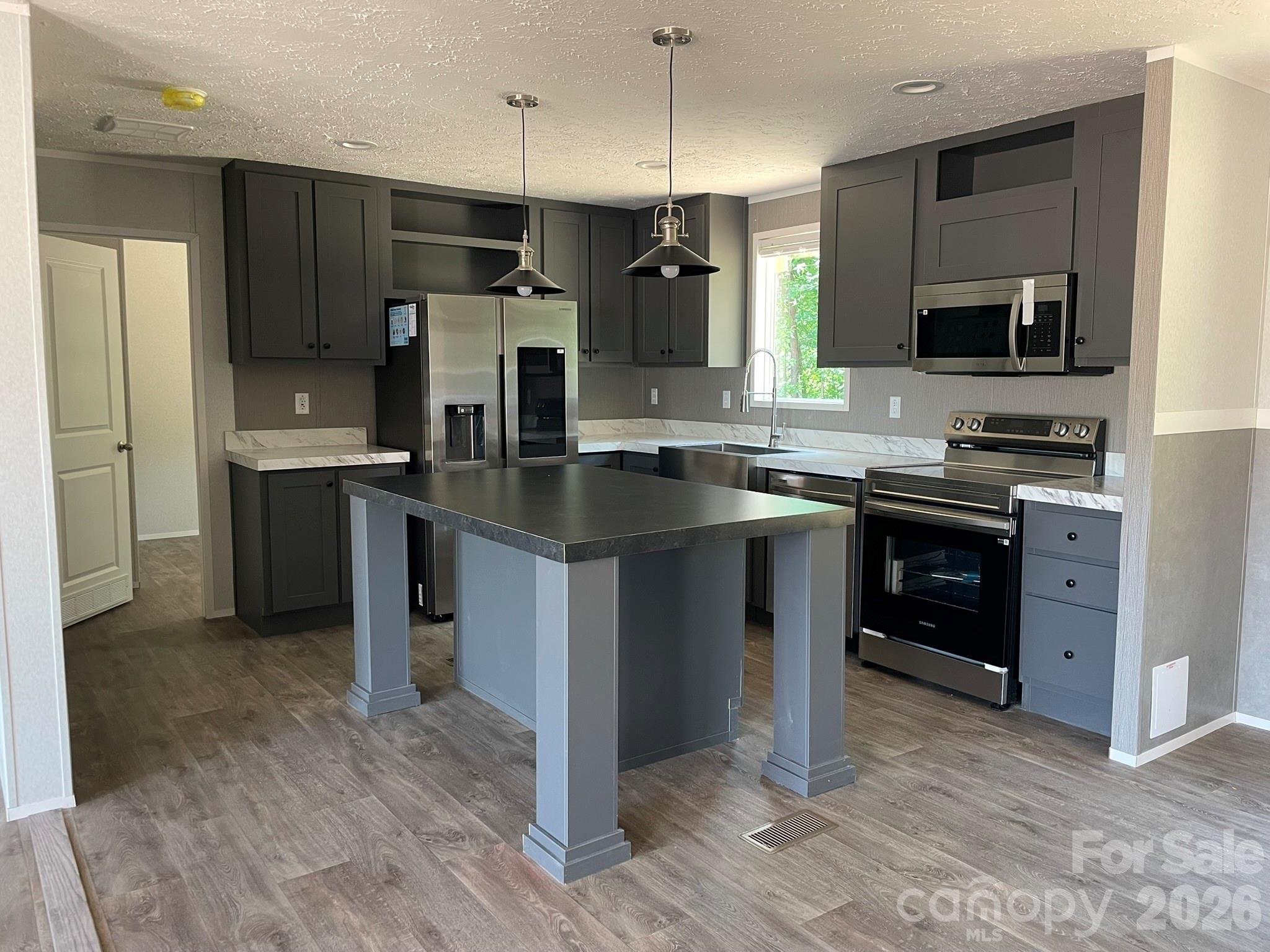 4188 Tallent Road Morganton, NC 28655 - Photo 7 of 21 a kitchen with stainless steel appliances granite countertop a sink stove and refrigerator