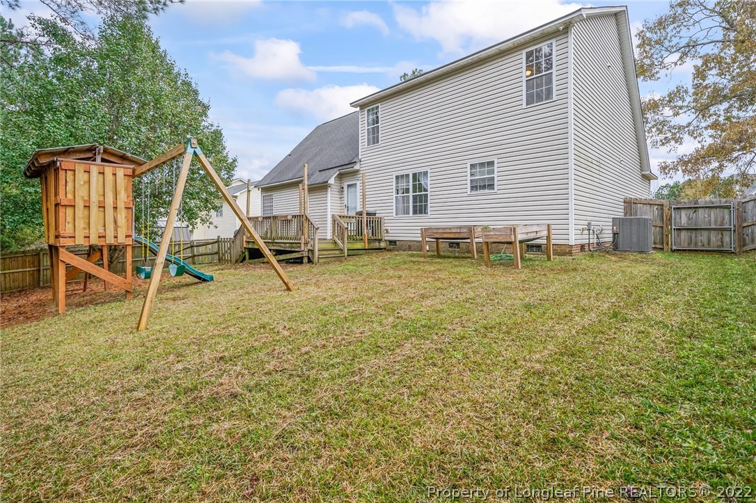 85 Pender Road Spring Lake, NC 28390 - Photo 36 of 45 a backyard of a house with table and chairs