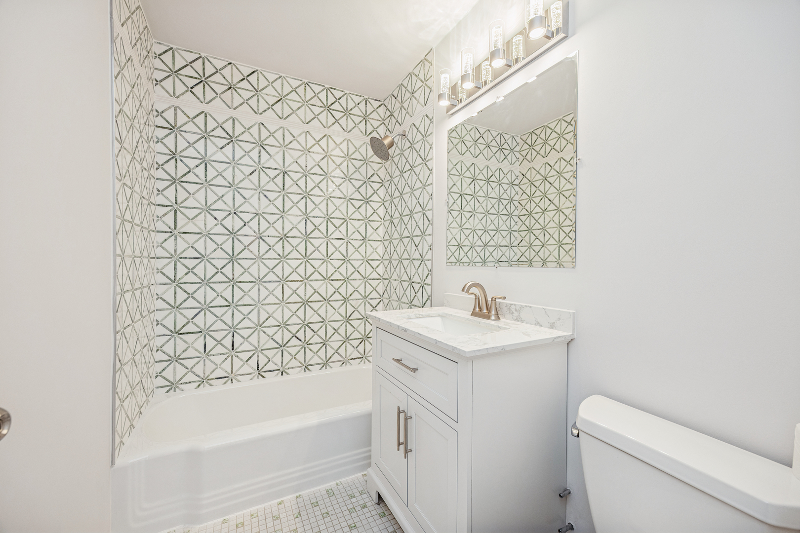 6301 North Sheridan Road, Unit 23J Chicago, IL 60660 - Photo 13 of 21 a bathroom with a sink a toilet and shower