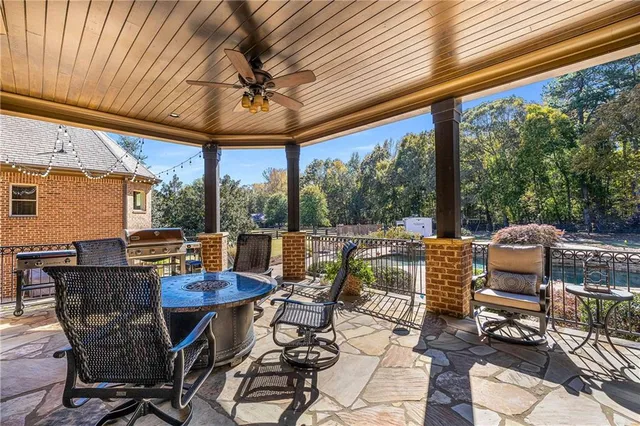 a kitchen with stainless steel appliances granite countertop a barbecue grill and cabinets